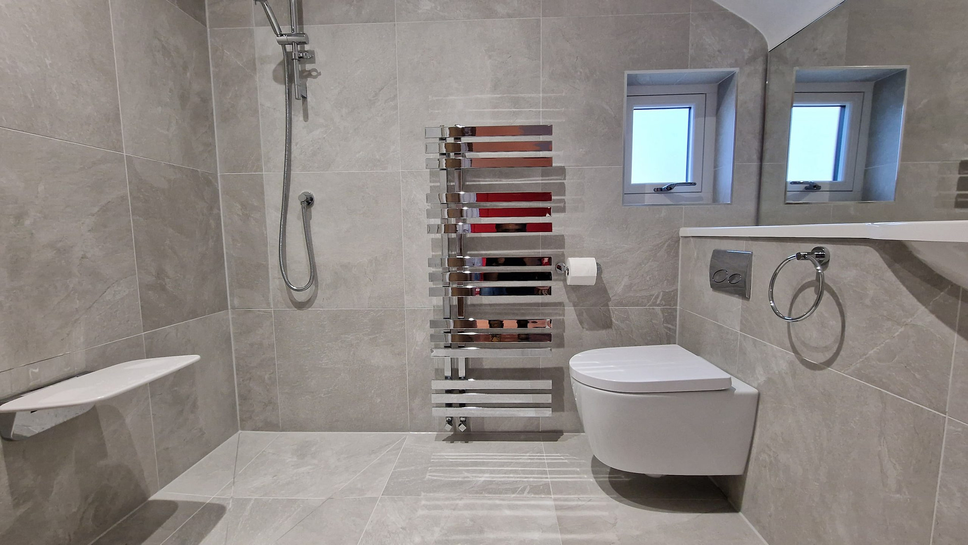 A bathroom with a toilet, sink, and shower.