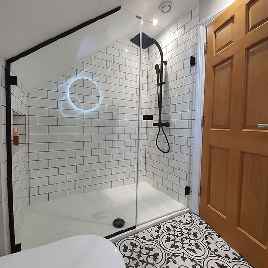 A modern bathroom featuring a sleek shower and a toilet.